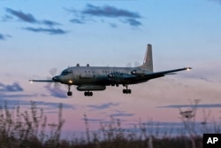 FILE - A photo taken on July 23, 2006 shows an Russian IL-20M plane landing at an unknown location.