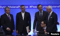 FILE - Russian lead negotiator on Syria Alexander Lavrentyev, Iranian Deputy Foreign Minister Hossein Jaberi Ansari, Kazakh Foreign Minister Kairat Abdrakhmanov and U.N. Special Envoy for Syria Staffan de Mistura attend the fourth round of Syria peace talks in Astana, Kazakhstan.