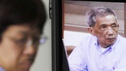 FILE - Kaing Guek Eav, also known as Duch, who ran the notorious Toul Sleng, a top-secret detention center for the worst "enemies" of the state, appears on a television screen of the press center of the U.N.-backed war crimes tribunal in Phnom Penh, 2010.