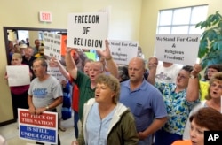 FILE - Rowan County Clerk Kim Davis’ supporters file into the courthouse in Morehead, Ky., Sept. 1, 2015. Davis refused to issue marriage licenses, defying a federal order.
