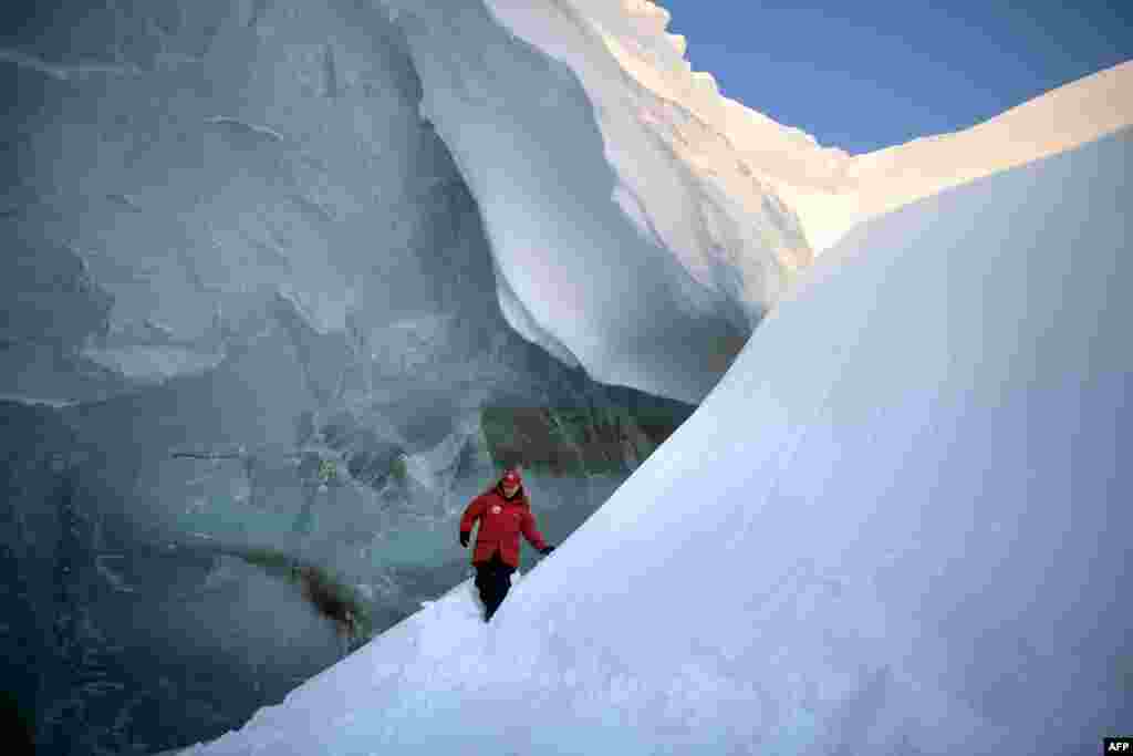 Russian President Vladimir Putin visits an ice cavern on Alexandra Land Island in the remote Arctic islands of Franz Josef Land, March 29, 2017.