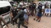 Police officers accused of complicity in the killing of a suspected drug dealer are brought to Nakhon Sawan Provincial Court, in Nakhon Sawan province, Thailand, Aug. 26, 2021. 