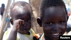 South Sudanese children displaced by fighting pose for a photo at a refugee camp in Jonglei, the country’s largest state, on April 29, 2014.