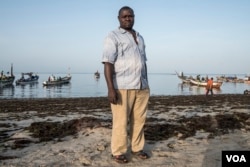 Saff Sall stands ashore for a quick portrait as his crew members load their fishing boat, which is headed to neighboring Guinea-Bissau for the next two weeks, May 30, 2017. (R. Shryock/VOA)
