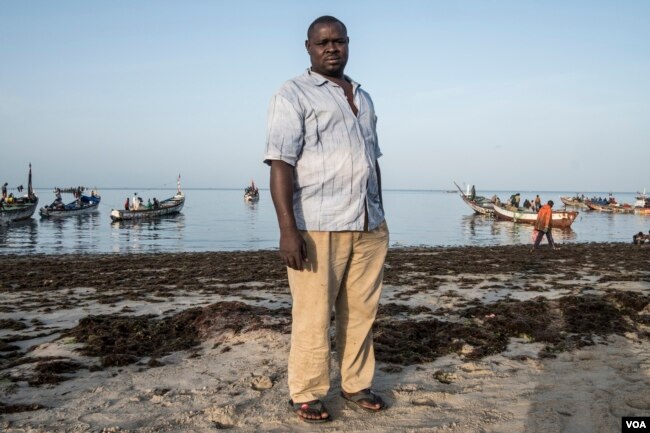 Saff Sall stands ashore for a quick portrait as his crew members load their fishing boat, which is headed to neighboring Guinea-Bissau for the next two weeks, May 30, 2017. (R. Shryock/VOA)