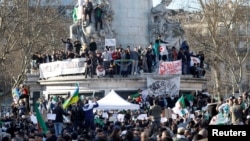 Demonstrators gather around the Monument to the Republic during a protest against President Abdelaziz Bouteflika seeking a fifth term in a presidential election set for April 18, in Paris, France, Feb. 14, 2019. 