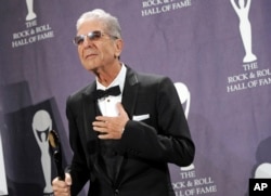 FILE - Leonard Cohen poses backstage at the Rock and Roll Hall of Fame Induction Ceremony, March 10, 2008, after he was inducted in New York.