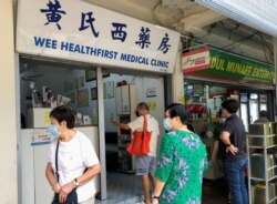 Orang-orang mengantri untuk menanyakan vaksin Sinovac di sebuah klinik, di tengah pandemi COVID-19 di Singapura, 18 Juni 2021. (Foto: REUTERS/Chen Lin)