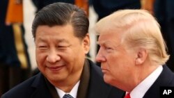 FILE - U.S. President Donald Trump and Chinese President Xi Jinping participate in a welcome ceremony at the Great Hall of the People in Beijing, China, Nov. 9, 2017.