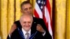 President Barack Obama awards chemist, and Nobel Prize winner Mario Molina with the Presidential Medal of Freedom during a ceremony in the East Room of the White House in Washington, Nov. 20, 2013.