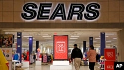 FILE - Shoppers walk into a Sears store in Pittsburgh, Pennsylvania, Feb. 8, 2017. Sears said that there is “substantial doubt” that it will be able to remain in business. The company, which runs Kmart and its namesake stores, has struggled for years with weak sales.