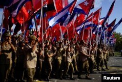 Army soldiers carry flags during the May Day rally in Havana, Cuba, May 1, 2018.