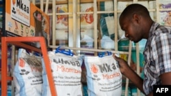 FILE - stocks environmentally friendly charcoal at his shop in Dar es Salaam on March 10, 2015.