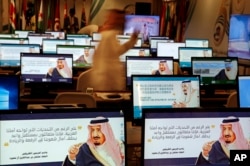 Screensavers showing King Salman are visible on computers at the press center for upcoming summits, in Mecca, Saudi Arabia, May 30, 2019.