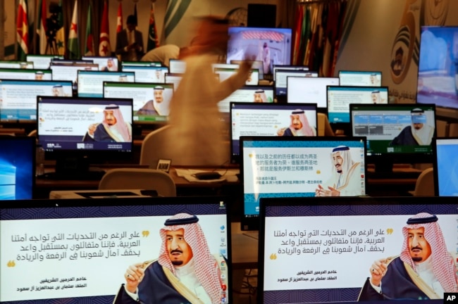 Screensavers showing King Salman are visible on computers at the press center for upcoming summits, in Mecca, Saudi Arabia, May 30, 2019.