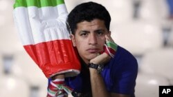 An Iranian soccer fan reacts after Iran lost to Iraq in the second preliminary round of the Asian qualifiers for 2012 London Olympics, at Azadi (Freedom) stadium in Tehran, June 23, 2011.