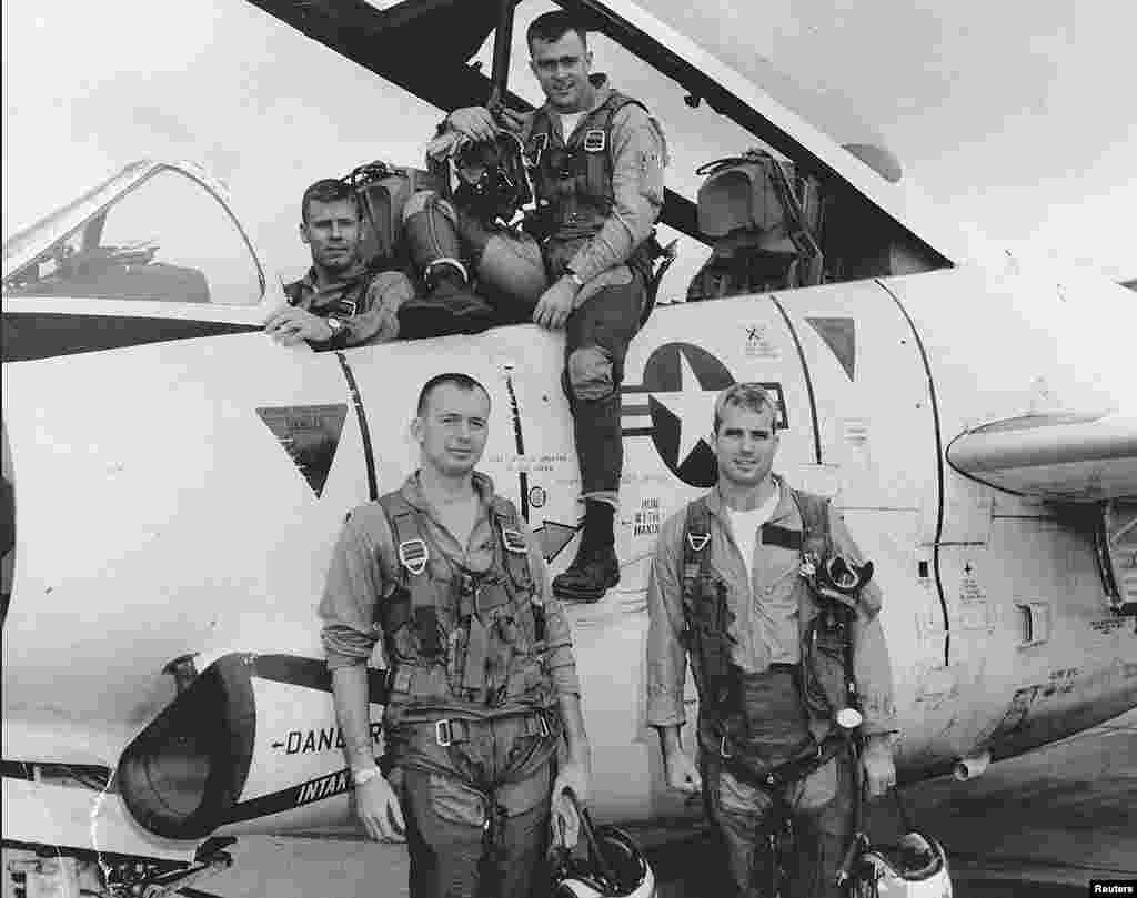 John McCain (Bottom R) poses with his U.S. Navy squadron in 1965. 