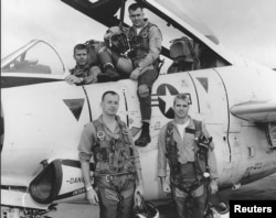 John McCain, bottom right, poses with his U.S. Navy squadron in 1965.