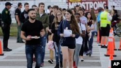 Students leave after attending class at Marjory Stoneman Douglas High School in Parkland, Fla., Wednesday, Feb. 28, 2018. Students returned to class for the first time since a former student opened fire there with an assault rifle, killing 17 people. (AP 