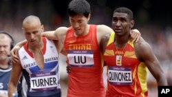 China's Liu Xiang is helped from the track by Britain's Andrew Turner, left, and Spain's Jackson Quinonez after falling in a men's 110-meter hurdles heat at the 2012 Summer Olympics, London, Aug. 7, 2012.