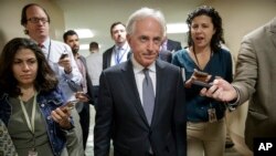 Senate Foreign Relations Committee Chairman Bob Corker, R-Tenn., talks to reporters as he returns to his office from a vote, on Capitol Hill in Washington, Oct. 25, 2017.