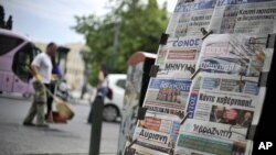 Newspapers are displayed in Athens. Europe's most indebted nation plunged into deep uncertainty after an election in which voters rejected mainstream pro-austerity parties, May 8, 2012.
