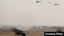 FILE - Pakistan's army tanks and helicopters, seen in this army-issued photo, take part in a military exercise in Khairpur Tamiwali, Pakistan.