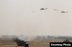 Pakistan's army tanks and helicopters, seen in this army-issued photo, take part in a military exercise in Khairpur Tamiwali, Pakistan, Wednesday, Nov. 16, 2016.