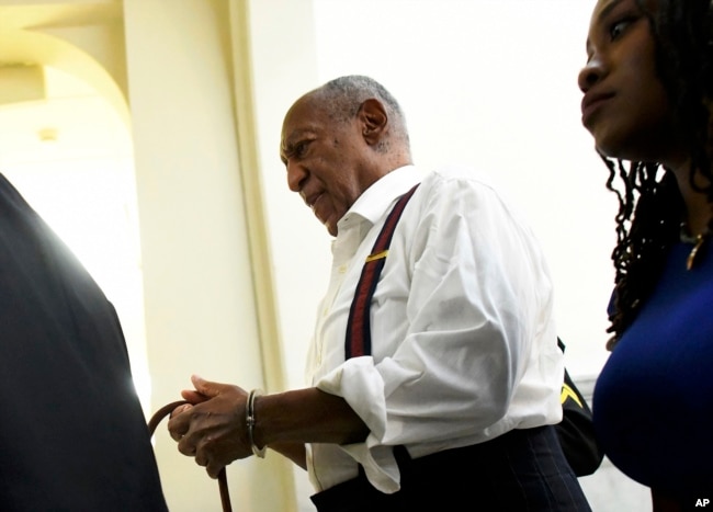 FILE - Bill Cosby is taken away in handcuffs after he was sentenced to three-to 10-years for felony sexual assault on Sept. 25, 2018, in Norristown, Pa.