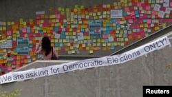 A woman looks at notes left by pro-democracy protesters on a footbridge in Hong Kong, Oct. 2, 2014.