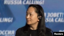 FILE - Meng Wanzhou, executive board director of the Chinese technology giant Huawei, attends a session of the VTB Capital Investment Forum "Russia Calling!" in Moscow, Oct. 2, 2014. 