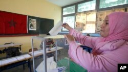 A Moroccan woman casts her ballot in a polling station for the municipal elections in Casablanca, Morocco, Sept. 4, 2015. 