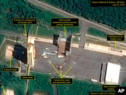 FILE - This July 22, 2018, satellite image released and annotated by 38 North on Monday, July 23, shows what the U.S. research group says is the partial dismantling of the rail-mounted transfer structure, at center, at the Sohae launch site in North Korea.