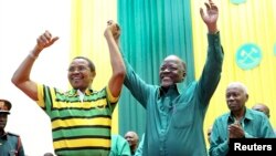 Tanzania's public works minister John Pombe Magufuli, right, celebrates with President Jakaya Kikwete, left, after the ruling party announced its presidential candidate, in Dodoma, Tanzania, July 12, 2015.