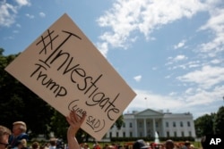 Demonstrators gather outside the White House in support of an investigation of Donald Trump, May 10, 2017.