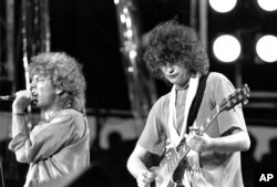 FILE - Singer Robert Plant, left, and guitarist Jimmy Page of the British rock band Led Zeppelin perform at the Live Aid concert at Philadelphia's J.F.K. Stadium, July 13, 1985.