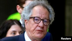 FILE - Australian actor Geoffrey Rush reacts as he arrives at the Federal Court in Sydney, Nov. 8, 2018.
