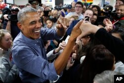 Former President Barack Obama smiles as he greets Democratic volunteers in a surprise appearance in Fairfax Station, Va., Nov. 5, 2018.