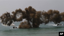 Amphibious assault vehicles fire smoke screen during a military exercise, Cobra Gold, on Hat Yao beach in Chonburi province, Thailand Friday, Feb. 14, 2014. About 8,000 military personnel from U.S., Thailand, Indonesia, Japan, Singapore, South Korea, and 