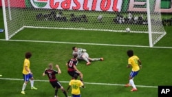 Germany's Andre Schuerrle scores his side's 6th goal during the World Cup semifinal soccer match between Brazil and Germany at the Mineirao Stadium in Belo Horizonte, Brazil, July 8, 2014.