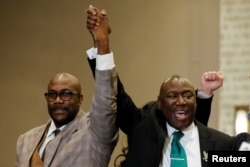 Floyd family attorney Ben Crump and Philonise Floyd raise their fists during a news conference following the verdict in the trial of former Minneapolis police officer Derek Chauvin, found guilty of the death of George Floyd, in Minneapolis, Minnesota