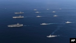 Three U.S. aircraft carriers USS Nimitz, left top, USS Ronald Reagan, left center, and USS Theodore Roosevelt, left bottom, participate, Nov. 12, 2017, with other U.S. and South Korean navy ships during the joint naval exercises between the United States and South Korea in waters off South Korea's eastern coast in South Korea.