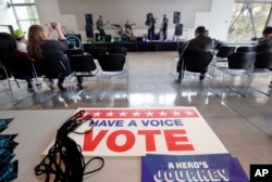 FILE - A small crowd watches the band Gypsy Temple during a performance by the group urging youth to participate in the November election at Shoreline Community College, Oct. 25, 2018, in Shoreline, Wash.