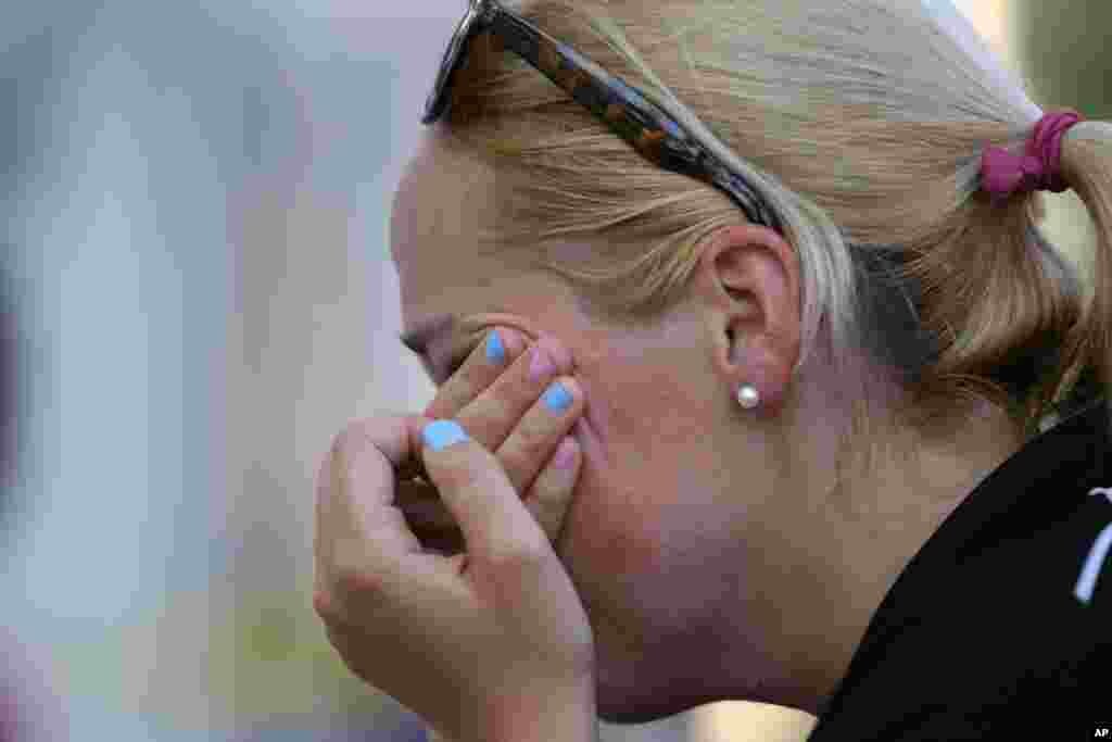 Rosie Frederick wipes her eyes after saying a prayer, June 18, 2015 at a make-shift memorial near the Emanuel AME Church following a shooting Wednesday night in Charleston, S.C.