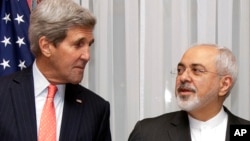 FILE - U.S. Secretary of State John Kerry, left, listens to Iran's Foreign Minister Mohammad Javad Zarif, right, before resuming talks over Iran's nuclear program in Lausanne, Switzerland.