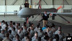 FILE - U.S. Defense Secretary Ash Carter addresses the U.S. troops as he stands in front of a drone at the Incirlik Air Base near Adana, Turkey, Dec. 15, 2015. 