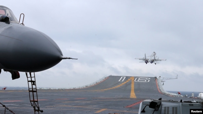 J-15 fighters from China's Liaoning aircraft carrier conduct a drill in an area of the South China Sea, on Jan. 2, 2017.