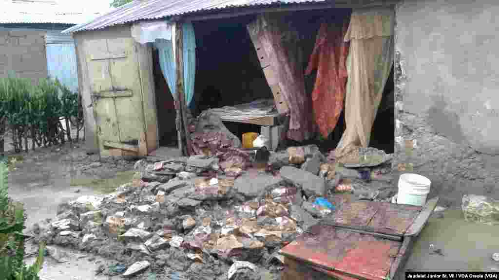 A home collapsed in Fort-Liberte, in northeast Haiti, because of Hurricane Irma's winds and rainfall, Sept. 7, 2017. One person is seen inside the home but no one was injured. 