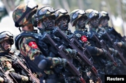 FILE - Myanmar military troops take part in a military exercise at Ayeyarwaddy delta region in Myanmar, Feb. 3, 2018.