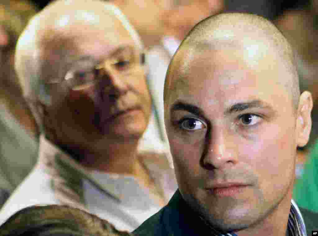 Feb. 19, 2013: Carl Pistorius, right, and Henke Pistorius, the brother and father of Olympic athlete Oscar Pistorius, charged with the shooting death of his girlfriend attend Oscar's bail hearing at the magistrate court in Pretoria, South Africa. 